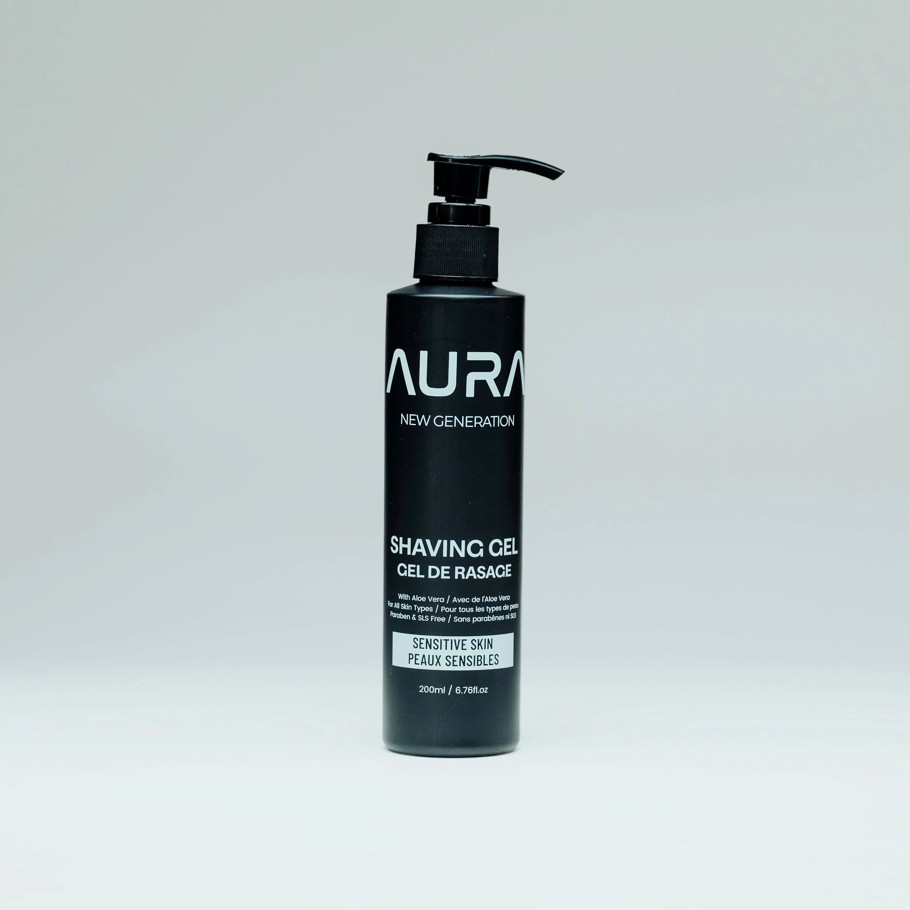 Black bottle of Aura shaving gel on a gray background