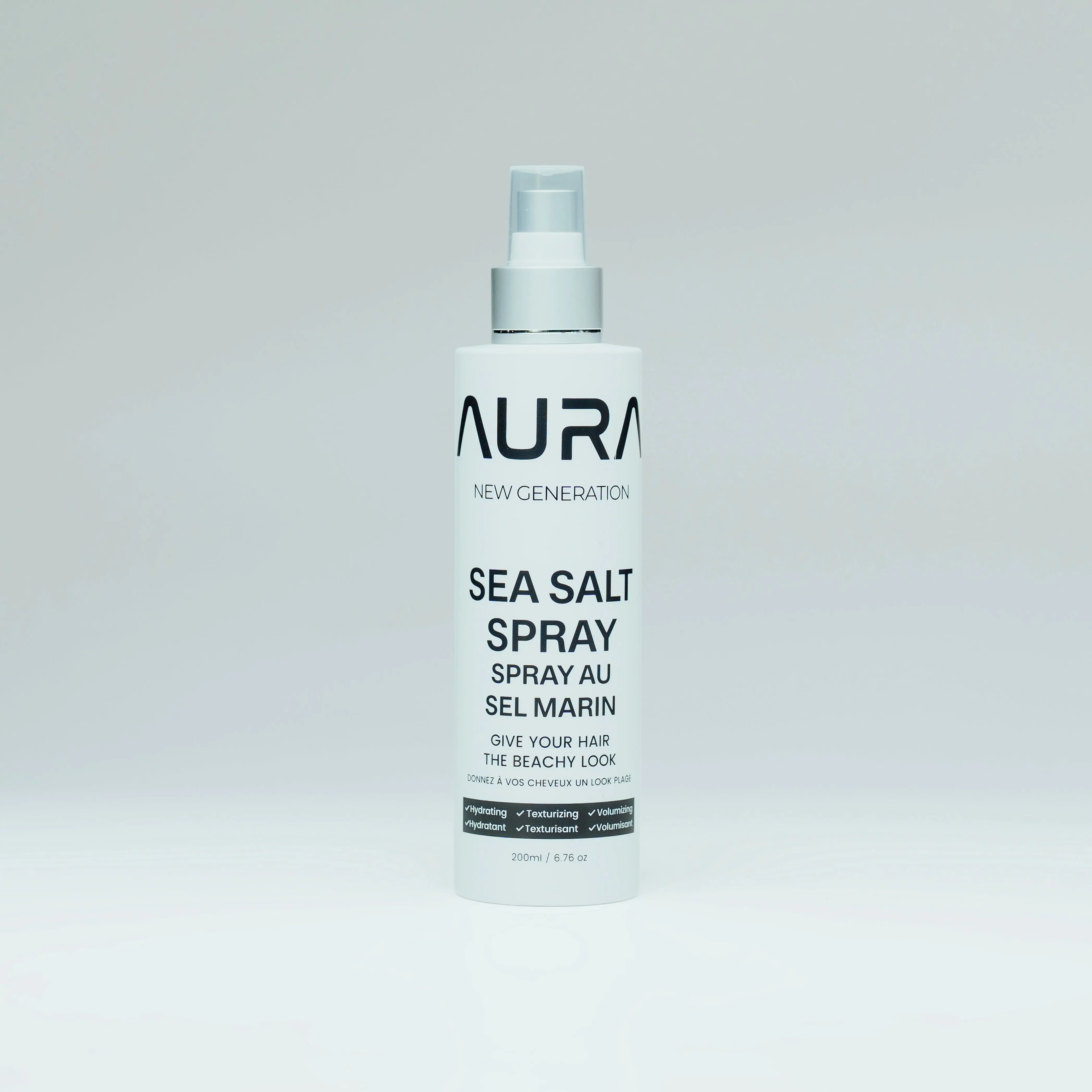 Bottle of Aura Sea Salt Spray on a light gray background