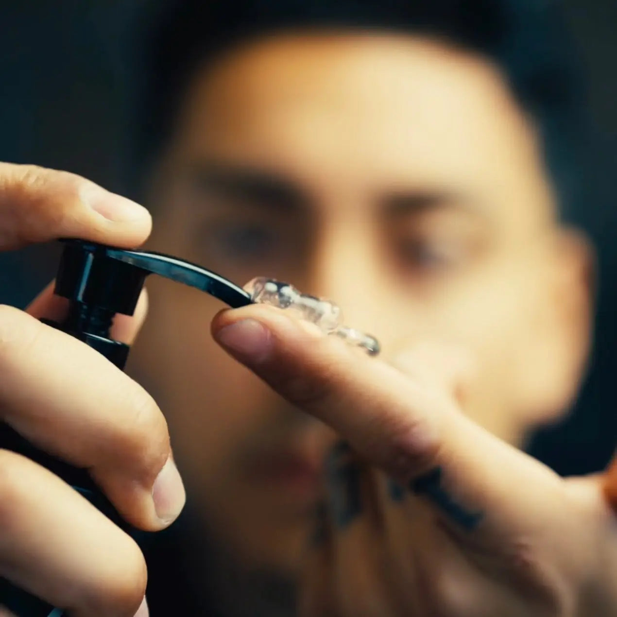 Person holding a small quantity of aura shaving gel with a blurred background